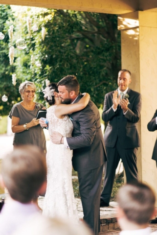 Bride and groom kiss in Hotel Escalante courtyard, Naples wedding