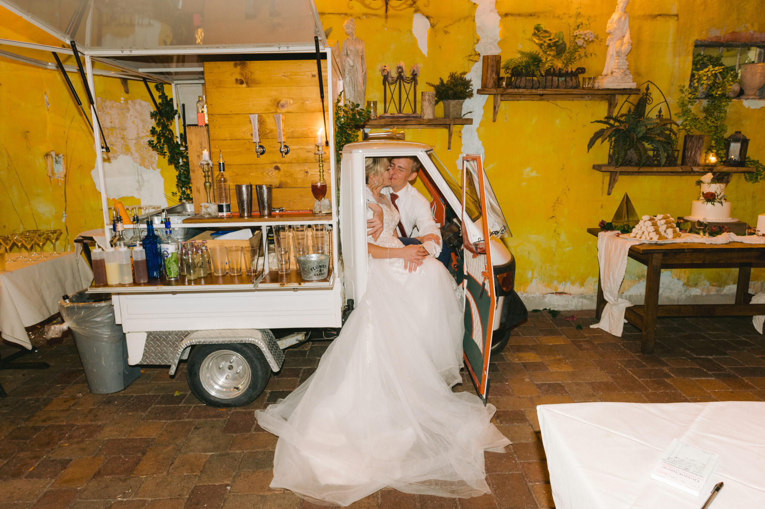 Newlyweds Katelyn and Dave share a romantic embrace inside a vintage mobile bar at their Gulf Port Saint Pete Beach wedding