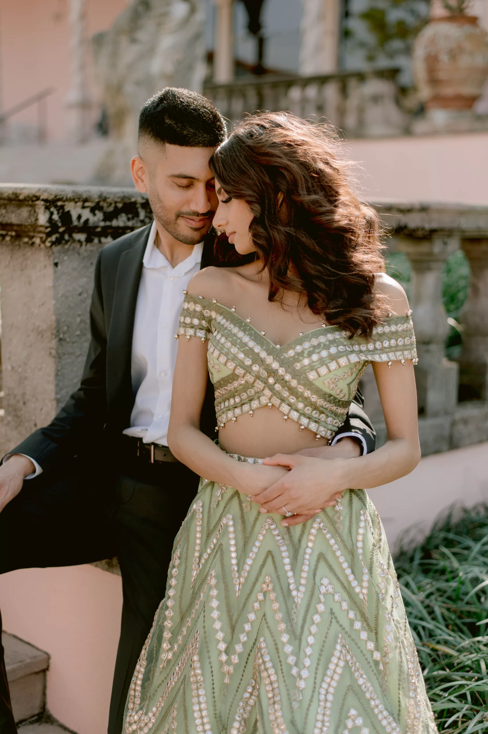 Rosh and Sab share an intimate moment during their Ringling Museum of Art engagement session, embodying the beauty of Desi love and tradition