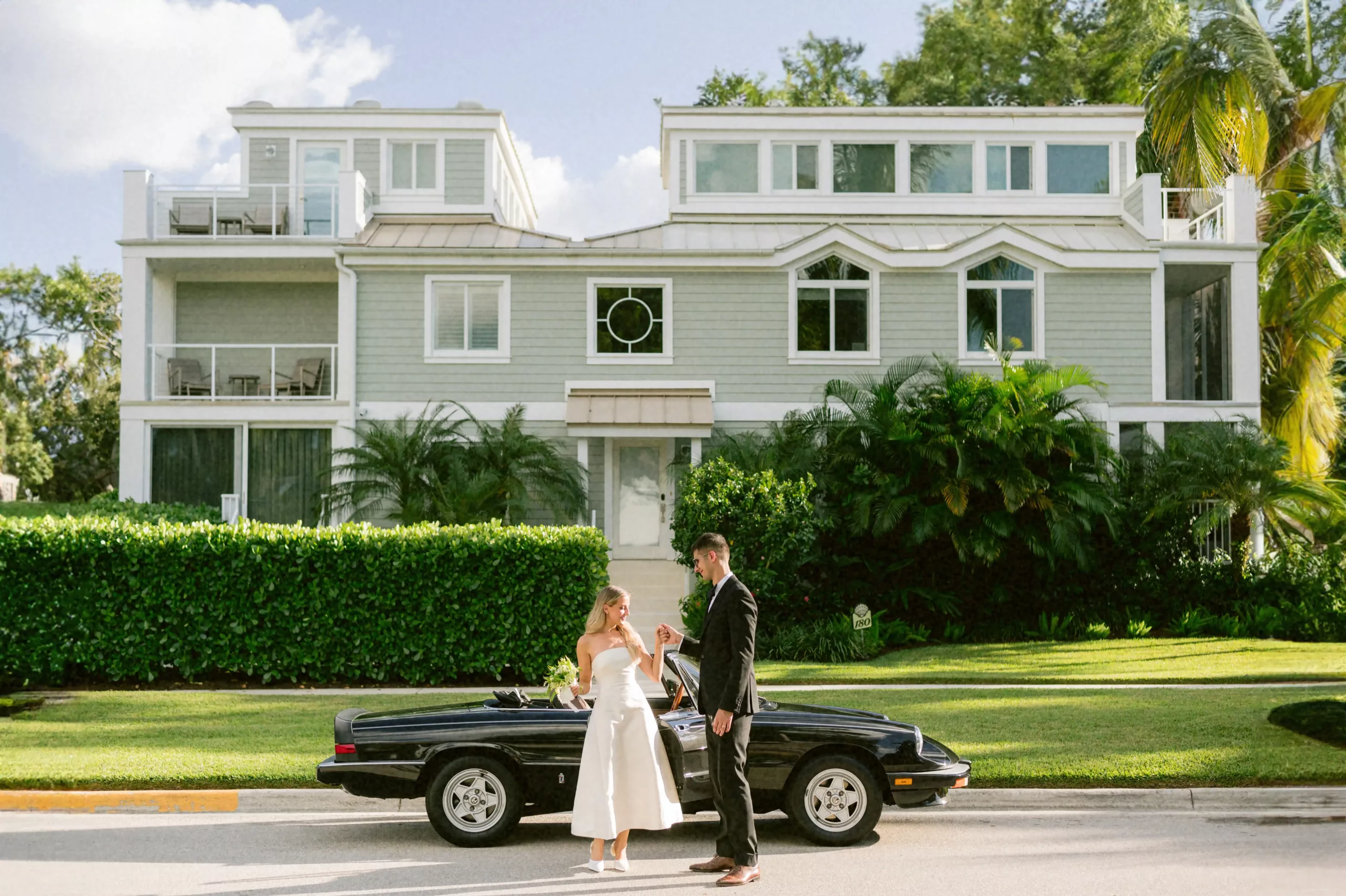 Brittany and Luka's chic elopement moment in Port Royal, Naples, Florida, with a vintage convertible, captured by Stills by Hernan, Tampa's leading editorial fine art wedding photographer