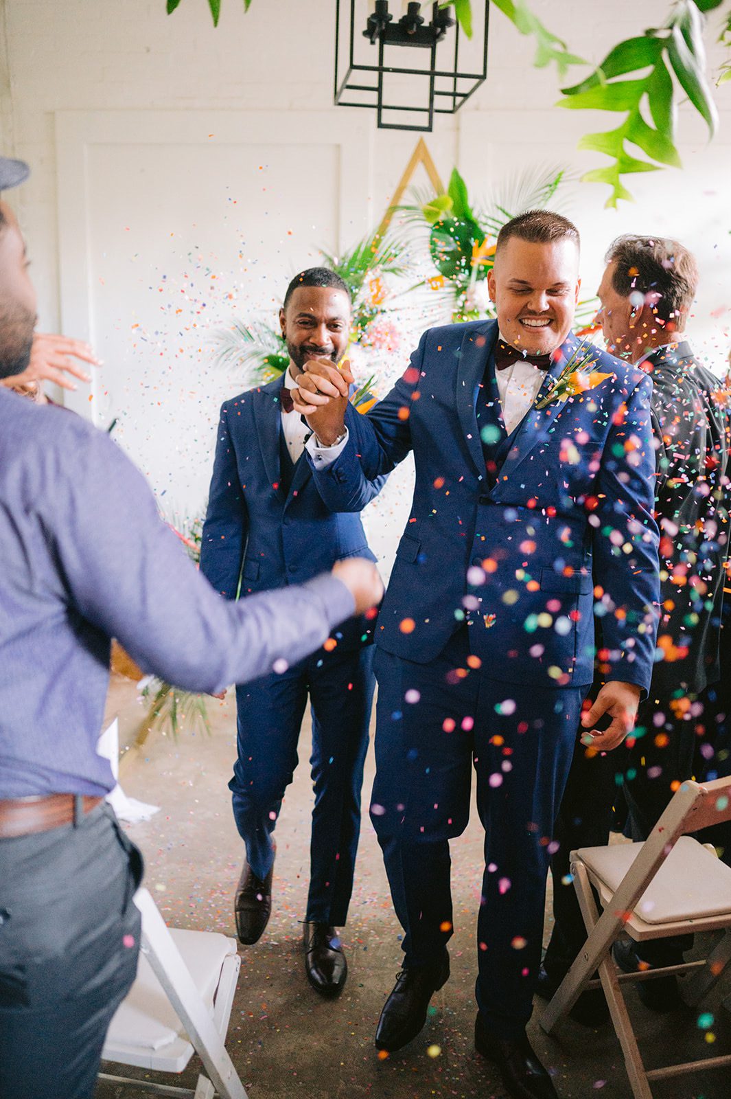 Shane and Craig's joyous exit as newlyweds at Fancy Free Nursery in Tampa, Florida, with colorful confetti showering down