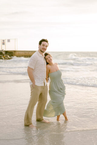 Gabby & Evan’s Sunset Pass-a-Grille Beach Engagement Photos | St. Pete Beach Photography by Stills by Hernan Gabby and Evan walk hand-in-hand during a sunset engagement session at Pass-a-Grille Beach in St. Pete Beach, Florida, photographed by Stills by Hernan