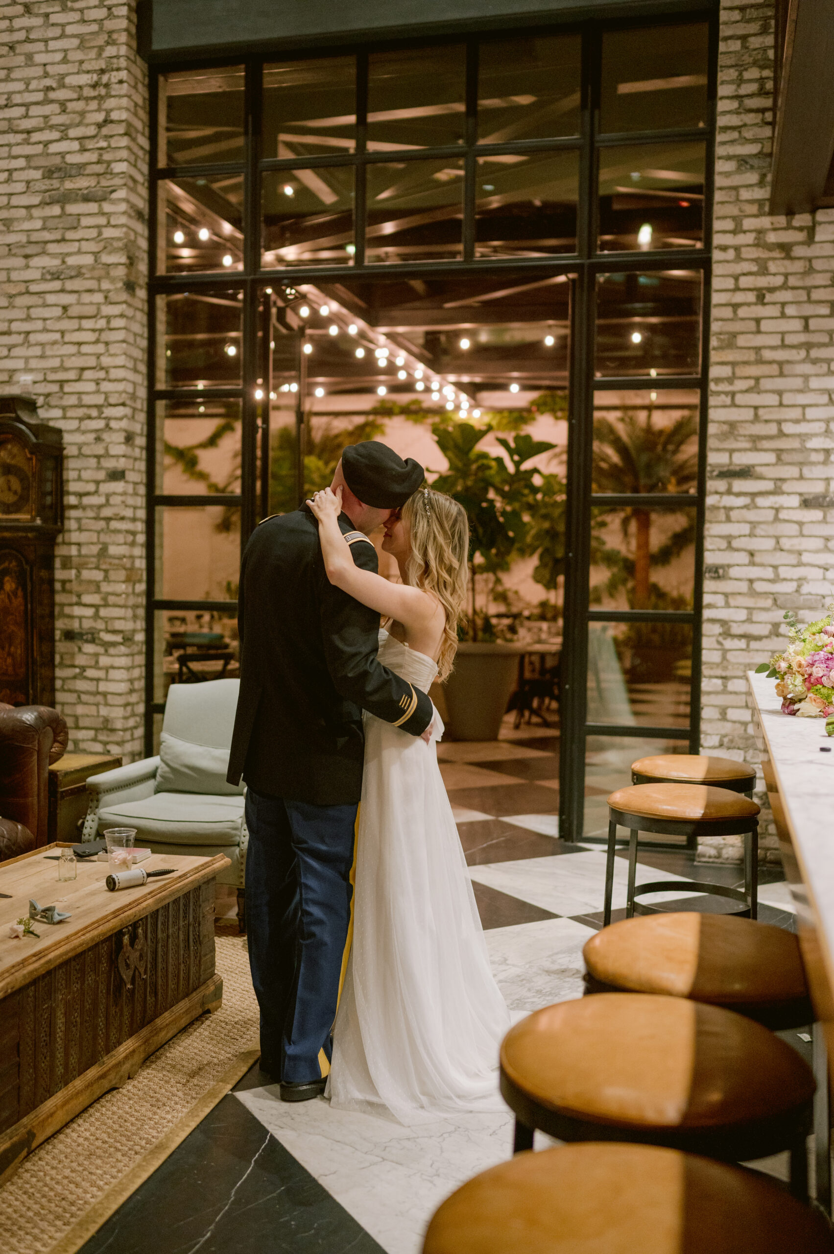 Sarah and Michael exchange vows in Oxford Exchange’s sunlit atrium, Tampa elopement photography by Stills by Hernan. Minimalist florals by @botanicafloralstudio